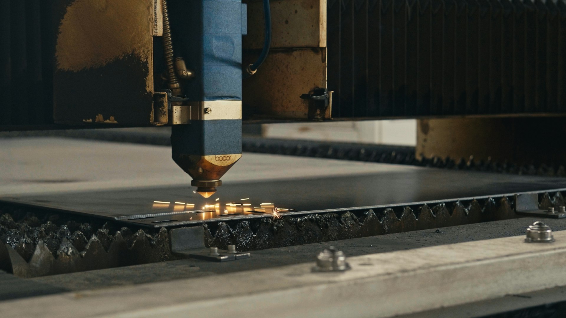 A machine that is cutting a piece of metal